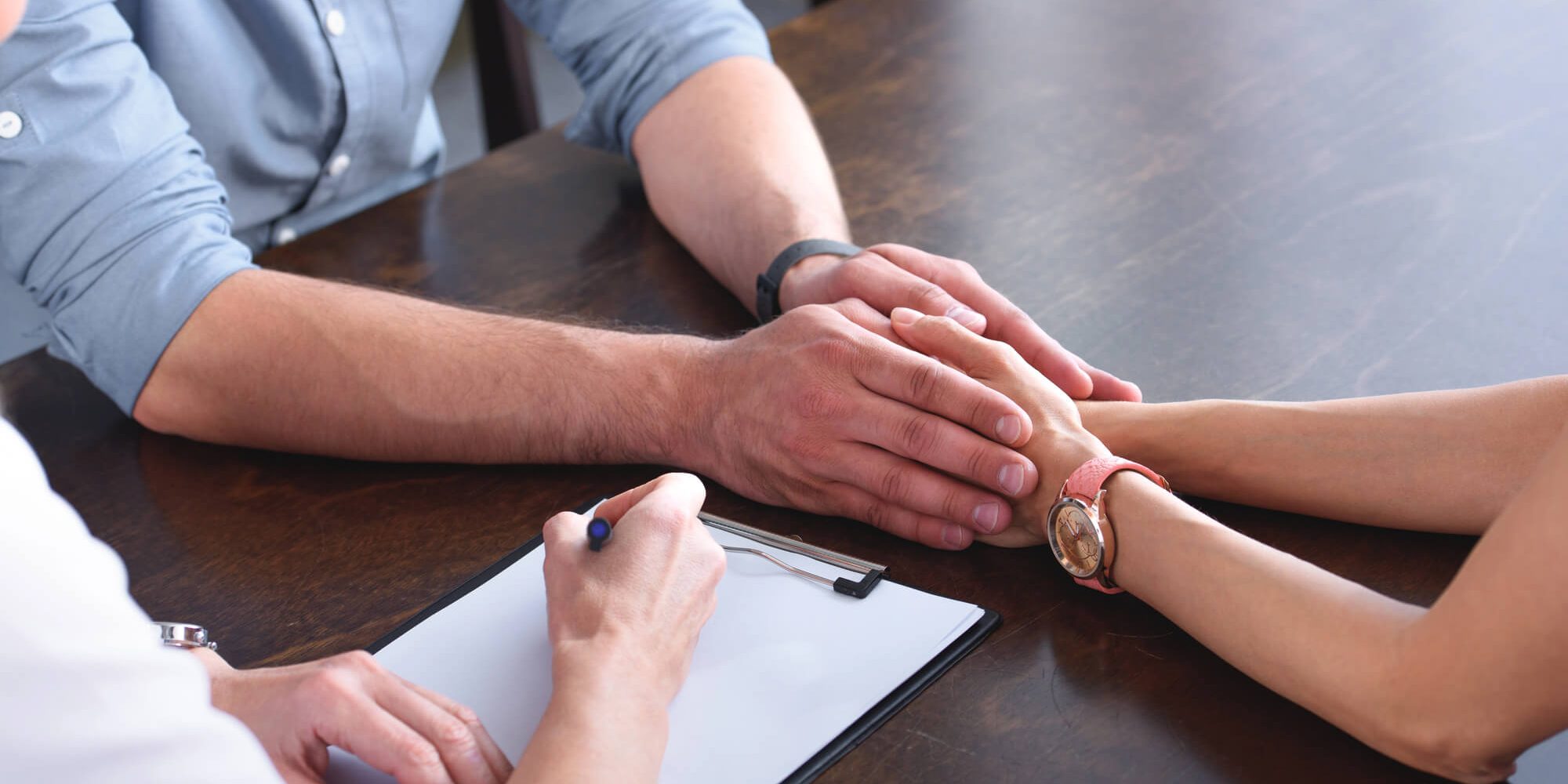 Family discussing deed of family arrangement in law office.