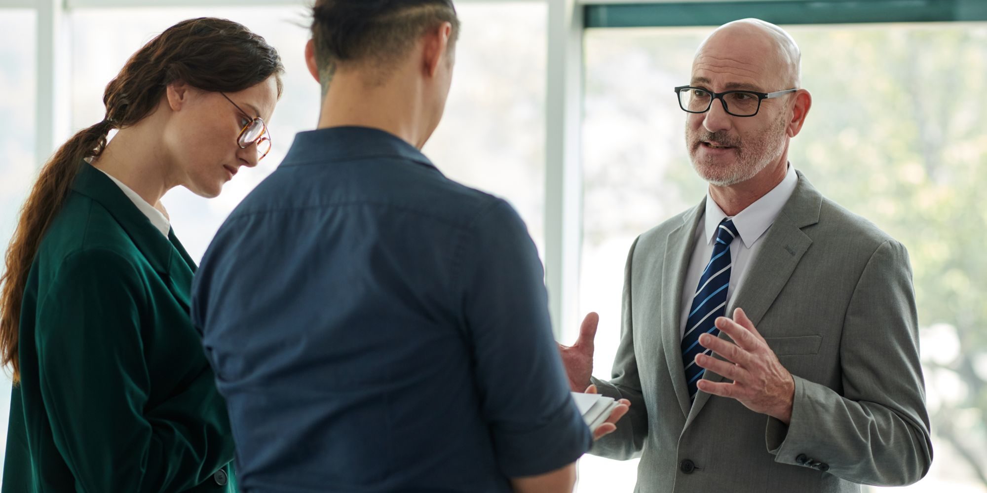Experienced lawyer giving legal advice to a couple about leaving a commercial lease.