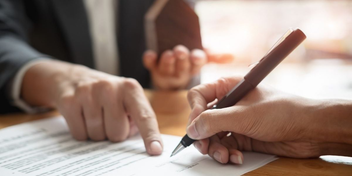 Someone signing a contract, subject to finance