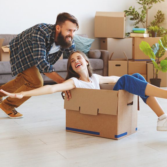 Happy family moving house following property law services.