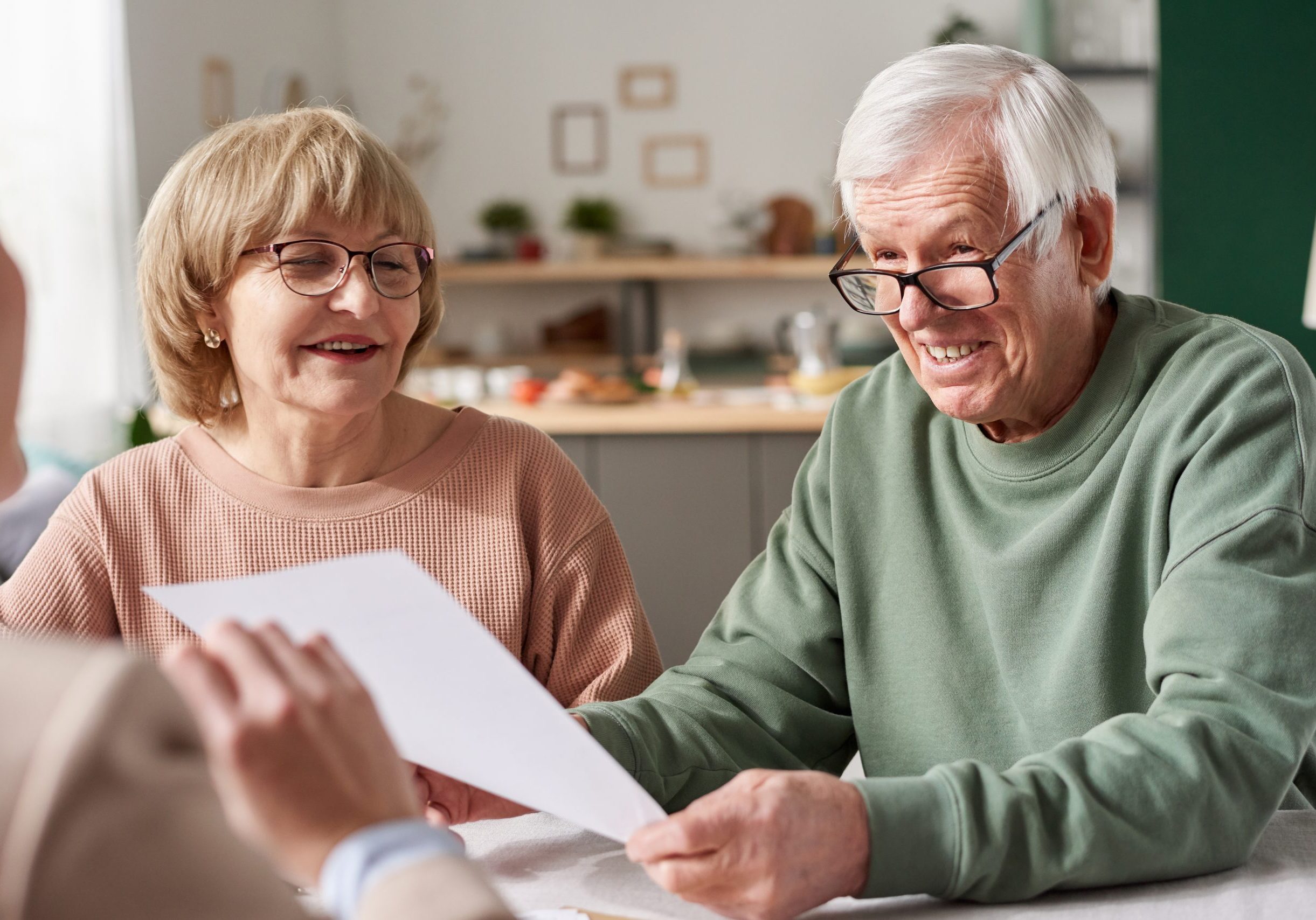 Senior couple signing wills & estate documents with Perth lawyers.